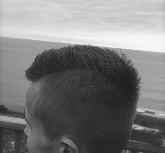 Bruno, cutting hair on the seaside in Porthleven, Cornwall